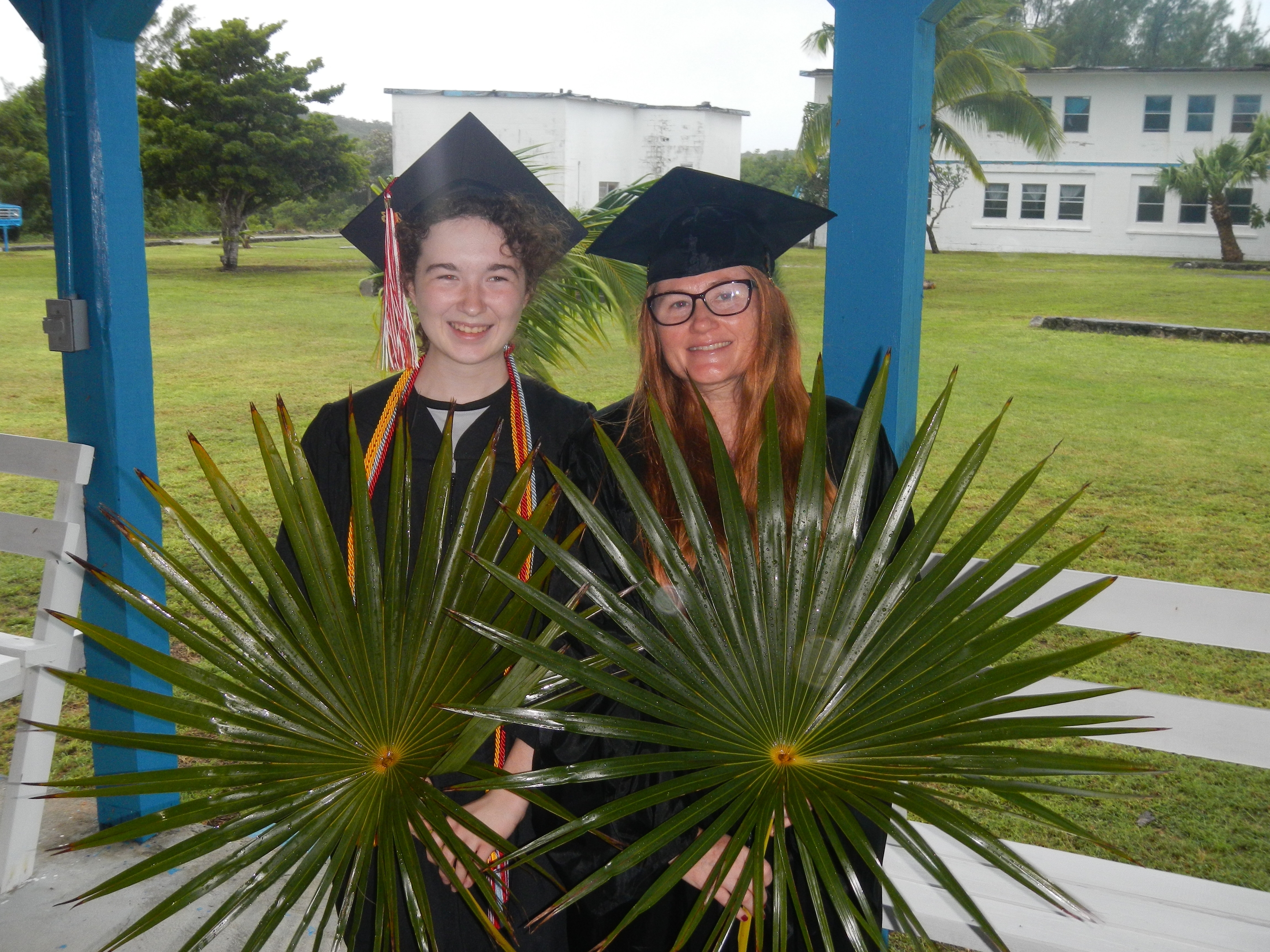 Graduates Darcy McTigue and Rachael Smith with their palm fronds