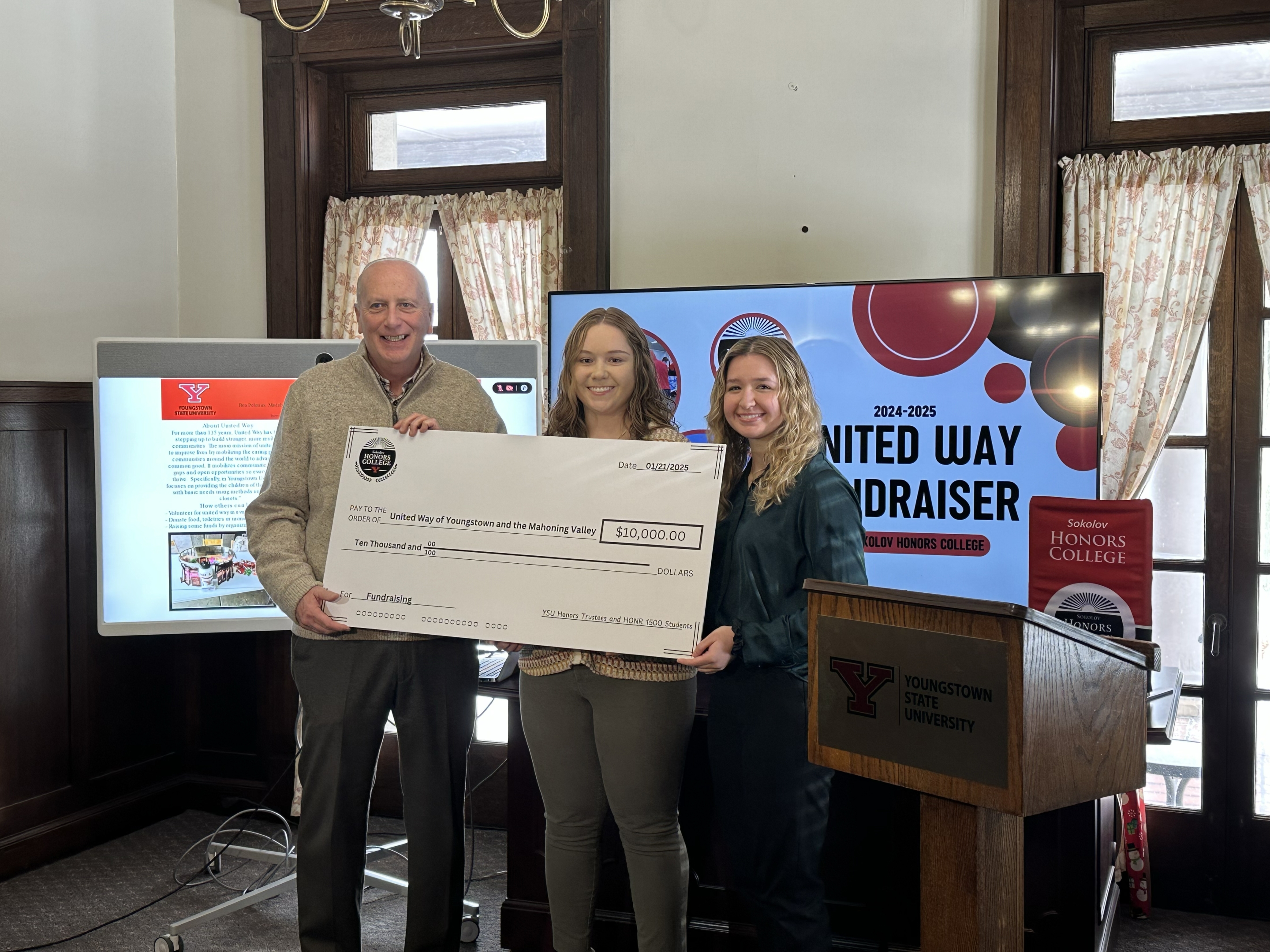 Honors Trustees present a $10,000 check to a representative of the United Way