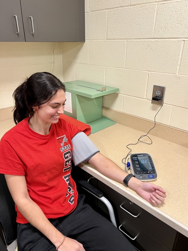 Student with Automated Blood Pressure Cuff on her arm