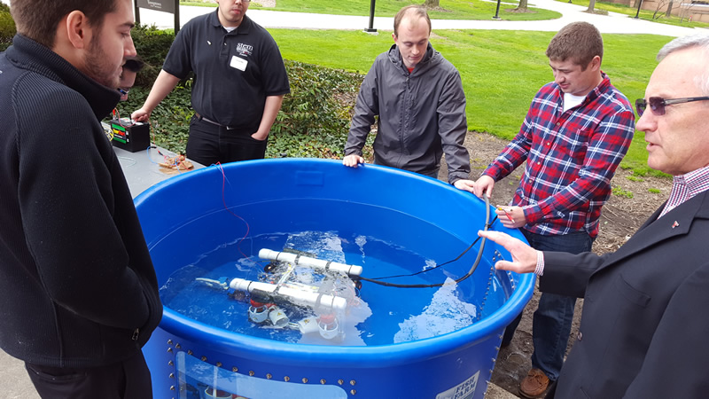 YSU students demonstrating experiment for President Tressel at STEM Showcase