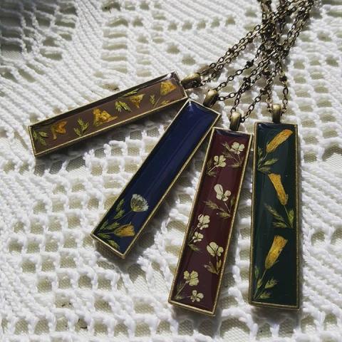 Necklaces with colored pendants and flower designs