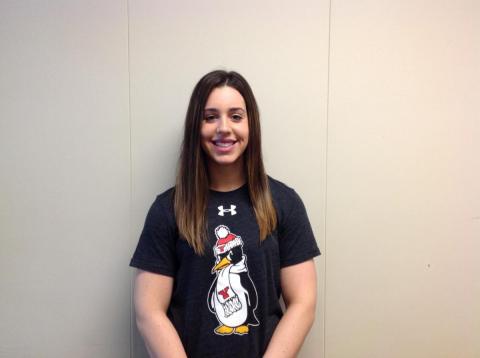 Smiling female student in a YSU t-shirt posing against a white background