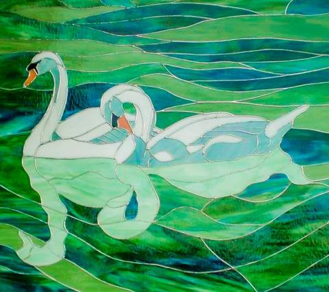 Stained glass swans swimming
