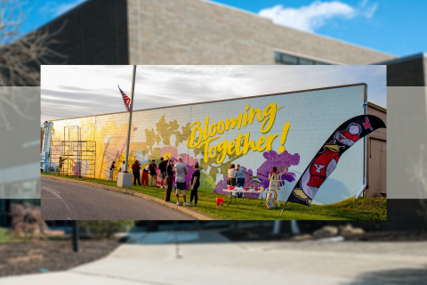 Community members, YSU faculty and students putting the finishing touches on a mural at Blooming Crazy Flowers and Gifts