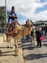 Student riding a camel in Irael