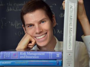 Man posing with mathematics books 