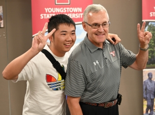 President Jim Tressel and a student in the Summer in America program pose for a photo during the con