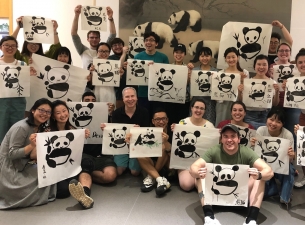 YSU students visiting Chengdu University and painting pandas using the traditional Chinese calligrap