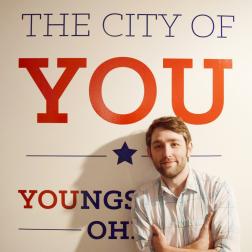 YSU professor RJ Thompson with City of You sign