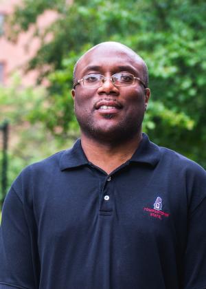 A headshot of Michael Beverly, staff member of Center for Student Progress, posing outside of the office on the campus of Youngstown State University