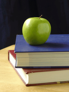A green apple and books